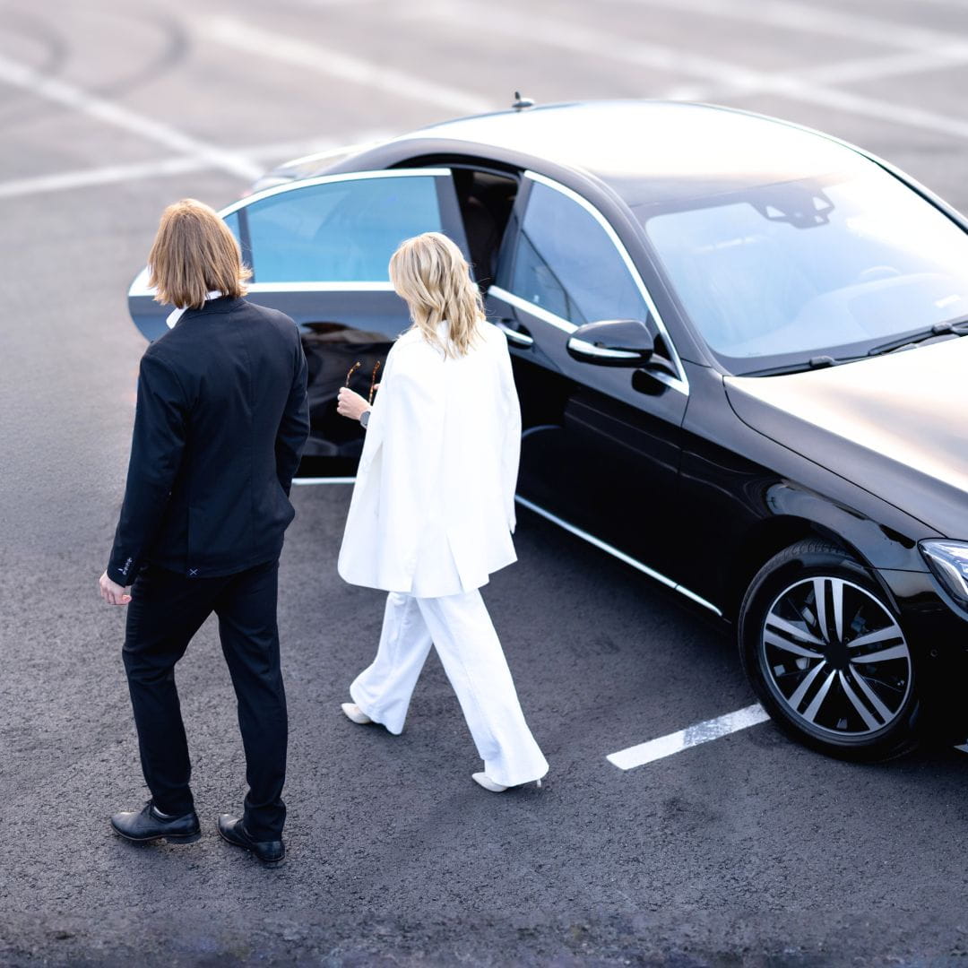 VIP passenger with bodyguard boarding a luxury vehicle on the tarmac for a diplomatic charter flight.